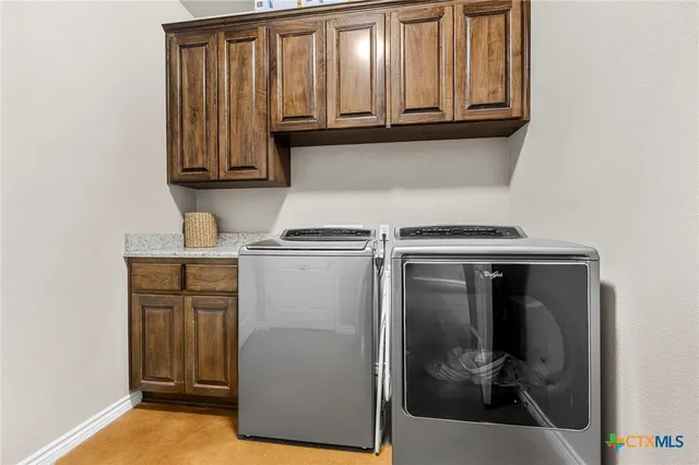 a view of walk in closet with clothes