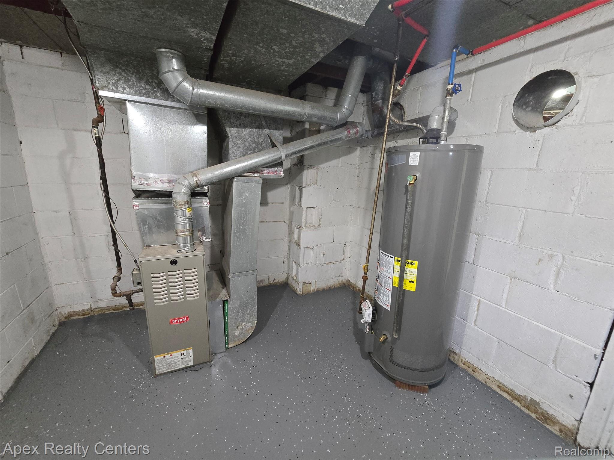 7671-7675 Evergreen Road Detroit, MI 48228 - Photo 53 of 84 7671 Evergreen. Dedicated utility area featuring a Bryant furnace, water heater, exposed ductwork, and white painted block walls