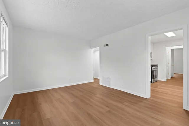 a view of a room with wooden floor and a large window