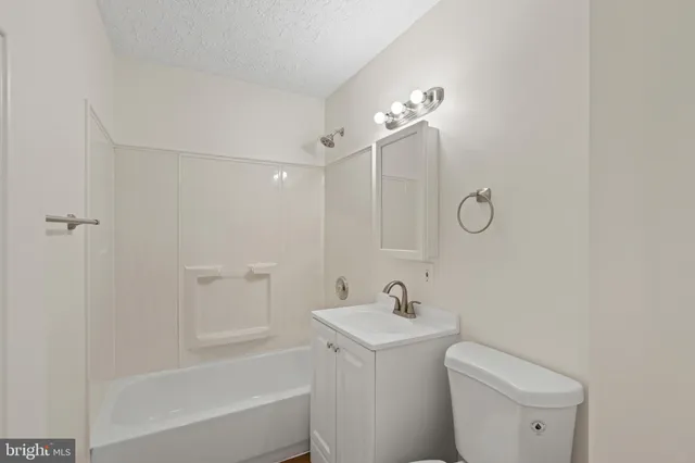 a bathroom with a toilet sink and shower
