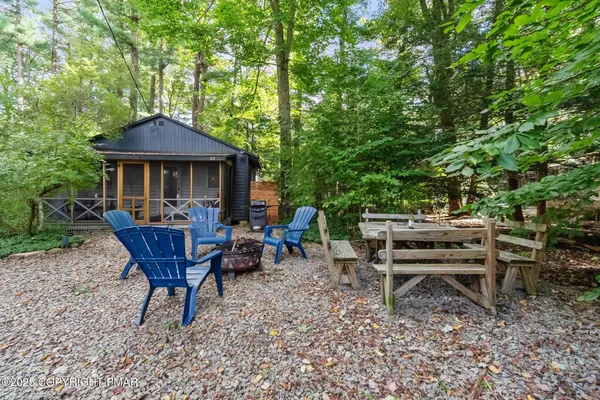 a view of a chairs and table in backyard