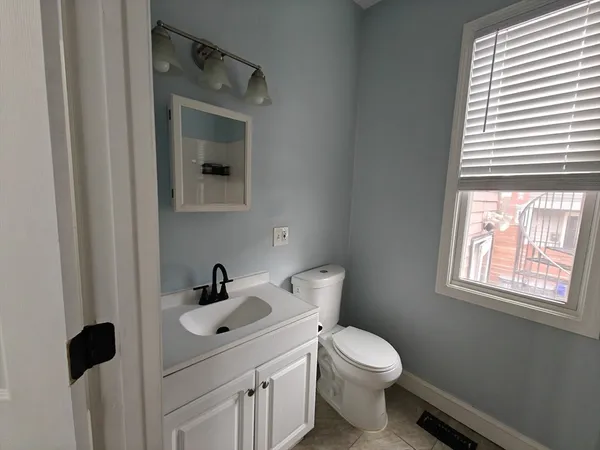 a bathroom with a sink toilet and mirror