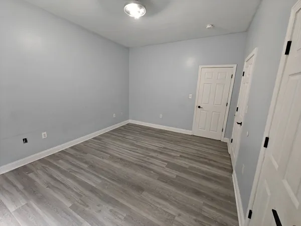a view of room with wooden floor