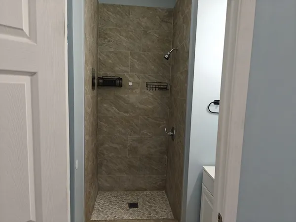 a bathroom with a glass shower door