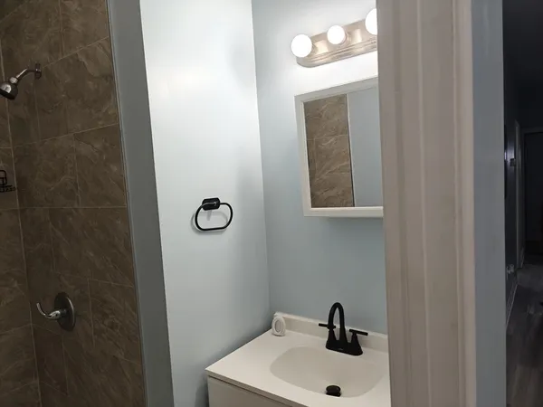 a bathroom with a sink and mirror