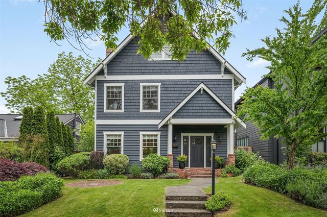 a front view of a house with a yard and porch