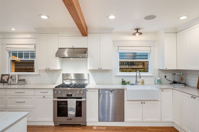 a kitchen with stainless steel appliances granite countertop a stove and a sink