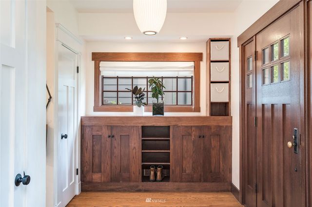 a view of kitchen with microwave and wooden floor