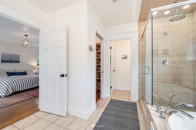 a bathroom with a sink a mirror and a shower