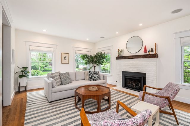 a living room with furniture a fireplace with wooden floor