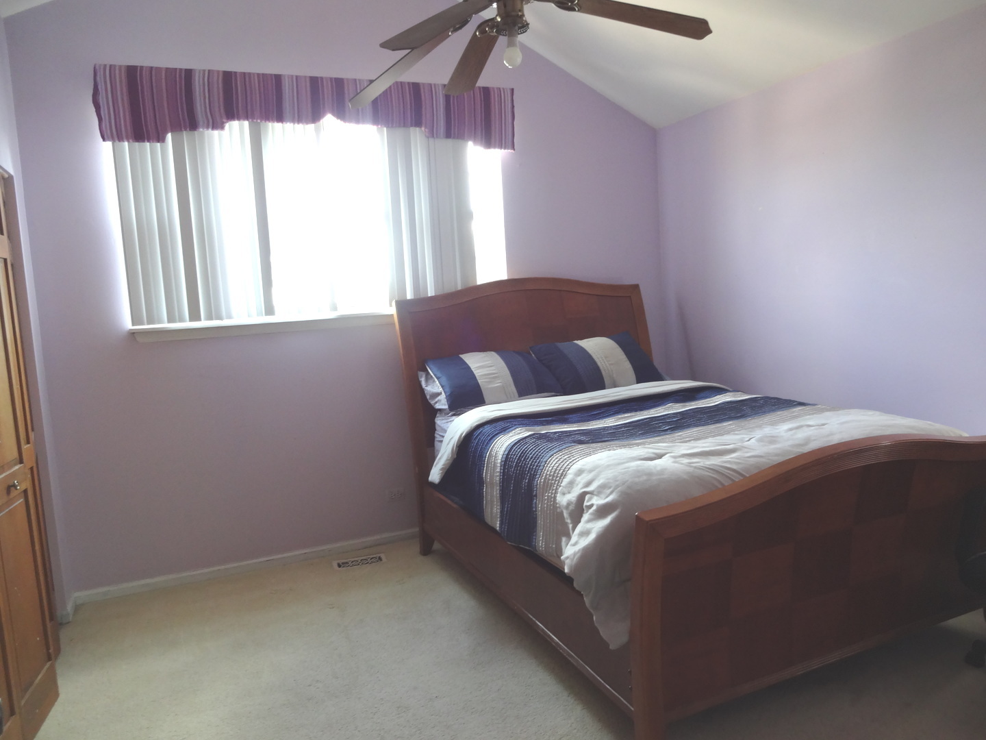 1340 Vernon Lane Bartlett, IL 60103 - Photo 19 of 24 a bed sitting in a bedroom next to a window