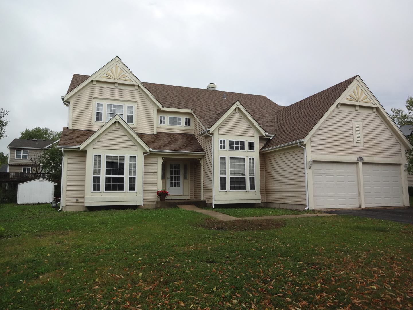 1340 Vernon Lane Bartlett, IL 60103 - Photo 2 of 24 a front view of a house with a yard and trees