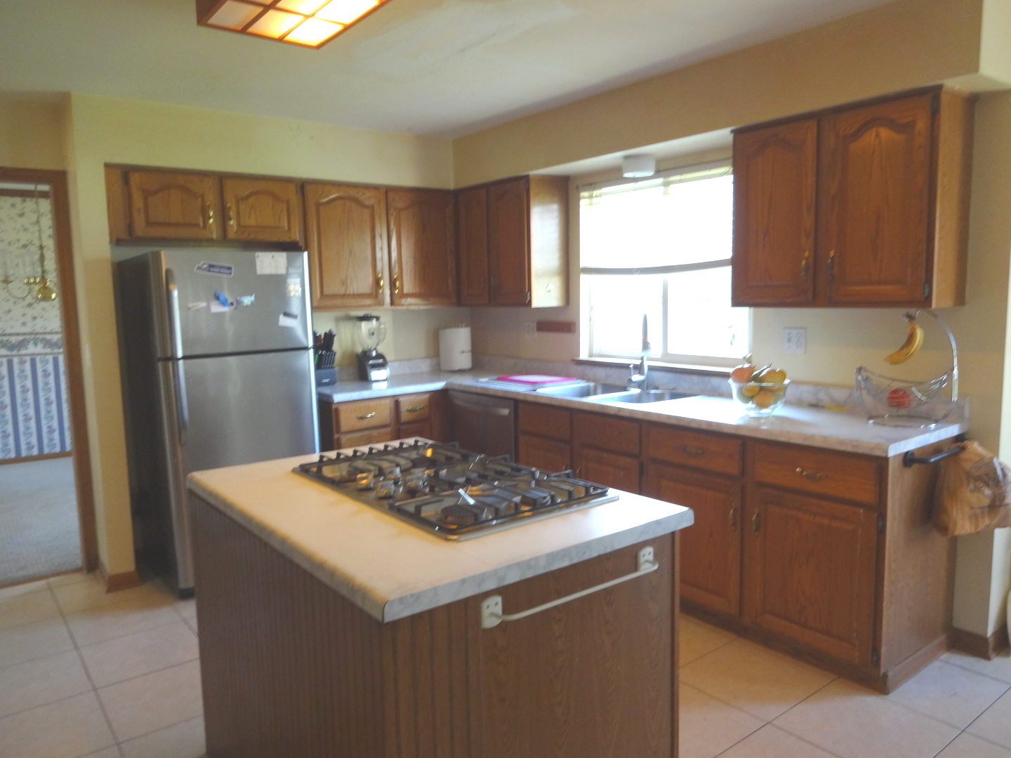 1340 Vernon Lane Bartlett, IL 60103 - Photo 6 of 24 a kitchen with a sink a stove a refrigerator and cabinets