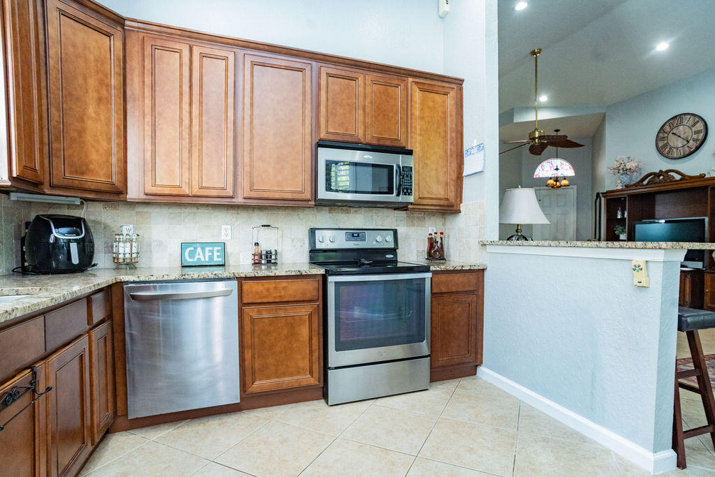 6020 Spring Lake Terrace Fort Pierce, FL 34951 - Photo 13 of 39 a kitchen with stainless steel appliances granite countertop a stove and a microwave