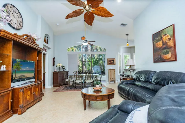 a living room filled with furniture and a window