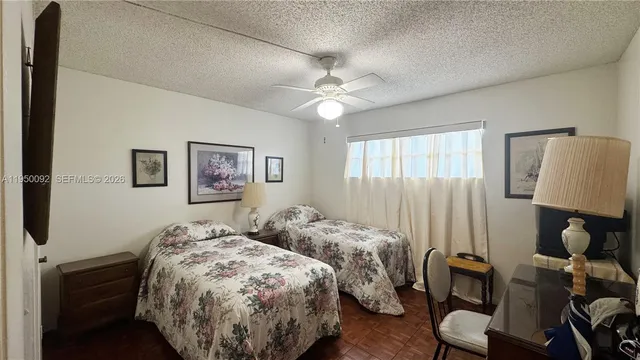 a bed room with two bed and a lamp