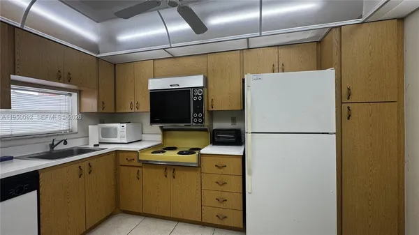 a white refrigerator freezer sitting in a kitchen