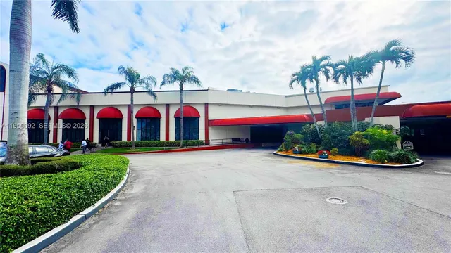 a view of swimming pool with a yard and potted plants