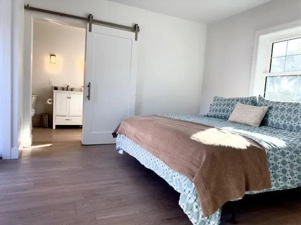 a bedroom with a bed and a window