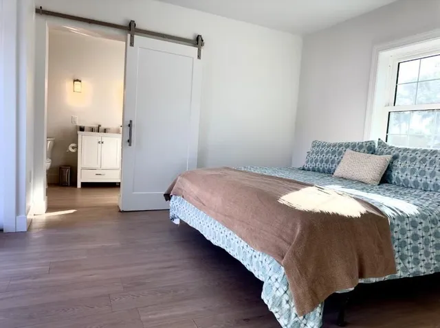 a bedroom with a bed and a window