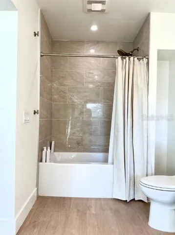 a bathroom with a bathtub and a shower
