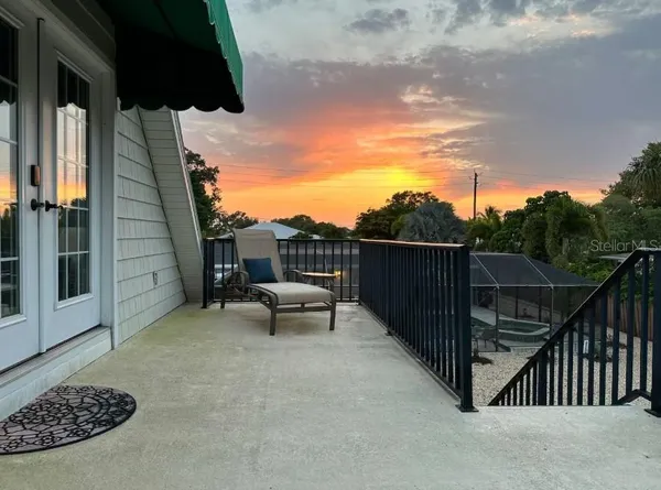 a view of a terrace with couches and wooden fence