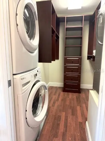 a view of walk in closet with clothes and shoes