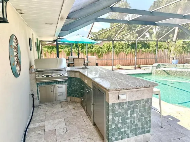 a kitchen with a stove and a white wooden cabinets