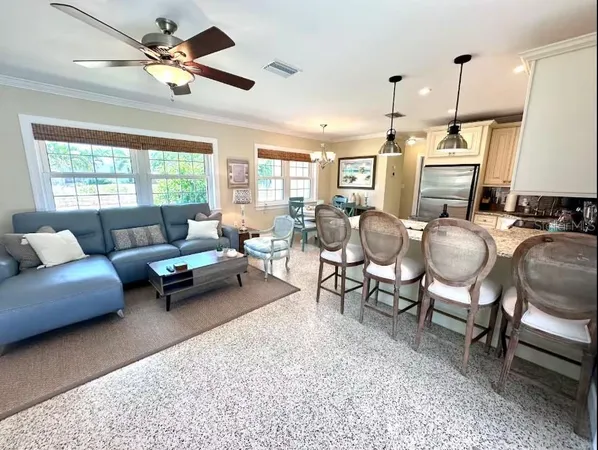a living room with furniture ceiling fan and a rug