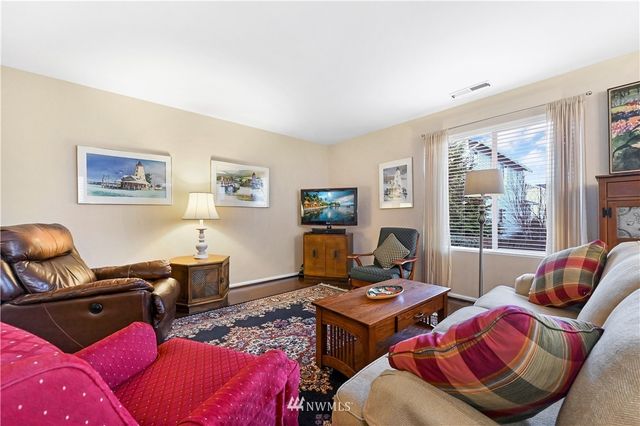 a living room with furniture rug and window