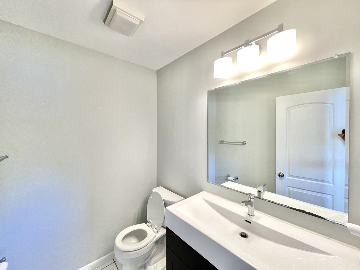 2250 Lakeside Drive Aurora, IL 60504 - Photo 11 of 26 a bathroom with a sink a toilet a mirror and shower