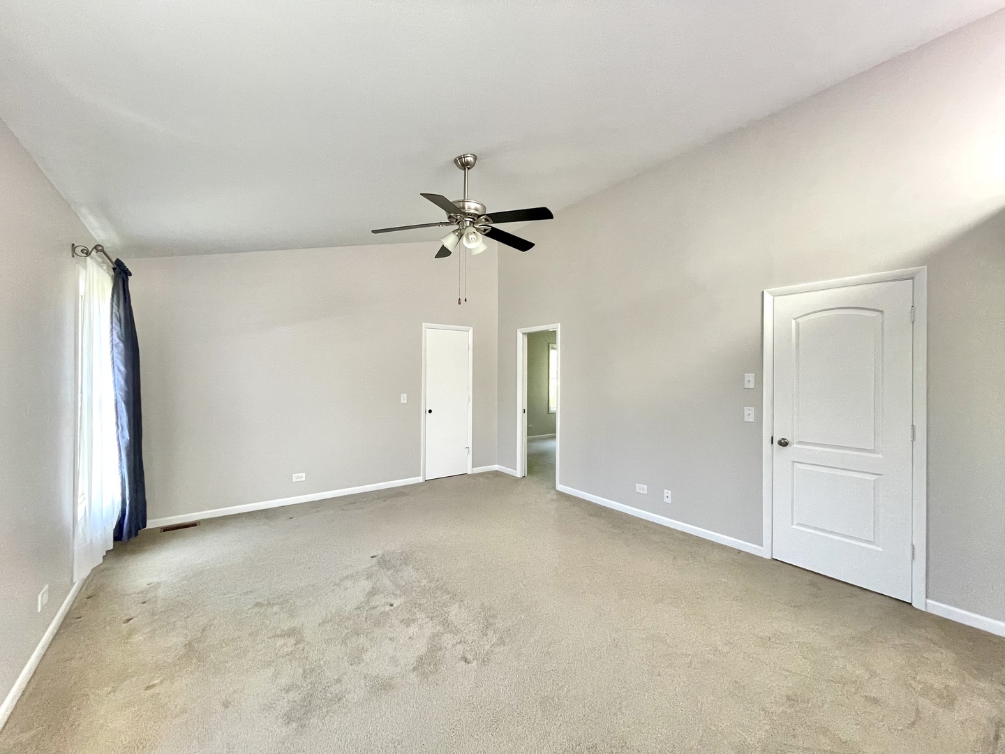 2250 Lakeside Drive Aurora, IL 60504 - Photo 17 of 26 an empty room with a ceiling fan and carpet