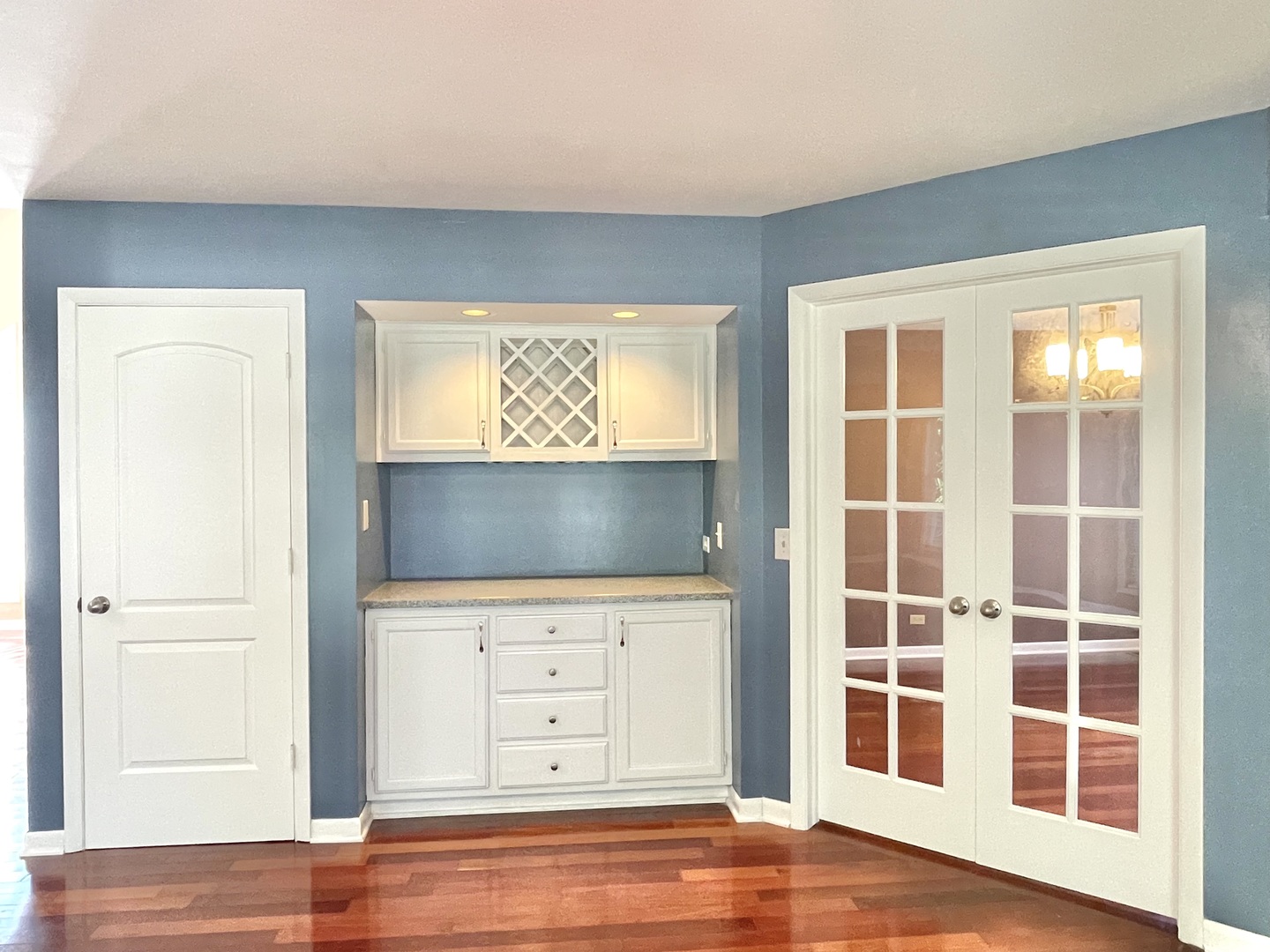 2250 Lakeside Drive Aurora, IL 60504 - Photo 5 of 26 an empty room with wooden floor cabinets and windows