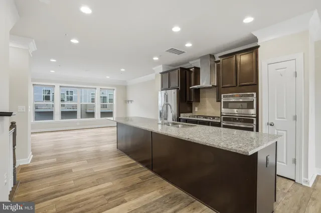 a kitchen with stainless steel appliances granite countertop a sink and stove
