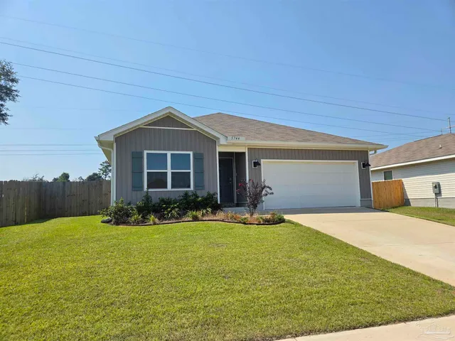 a front view of a house with yard and porch