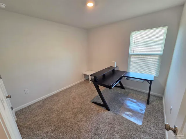 a bench sitting in a room next to a window