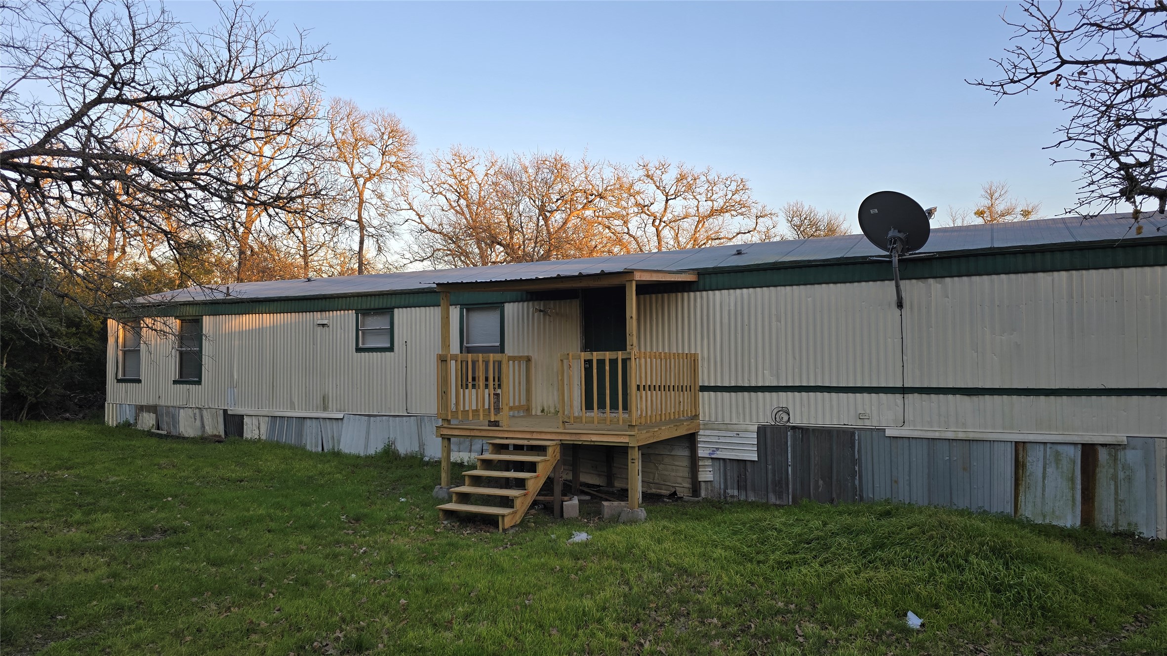 Back of property featuring a yard and a deck