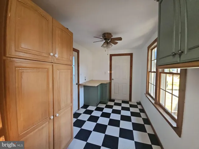 a view of a bathroom with a black and white checkered floor