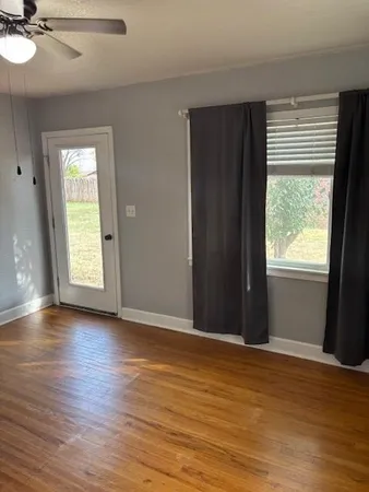 a front view of a house with a yard and trees