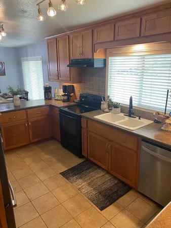 a kitchen with a sink stove and cabinets