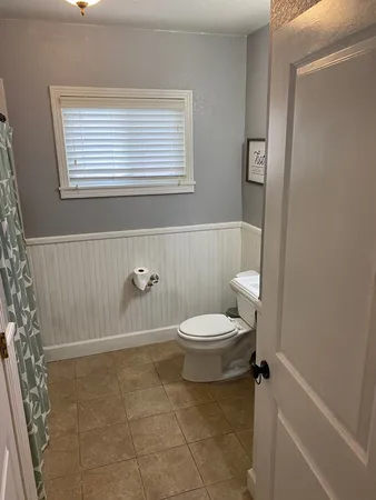 a bathroom with a toilet a sink and a shower