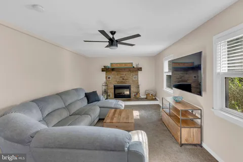 a living room with furniture a flat screen tv and a fireplace
