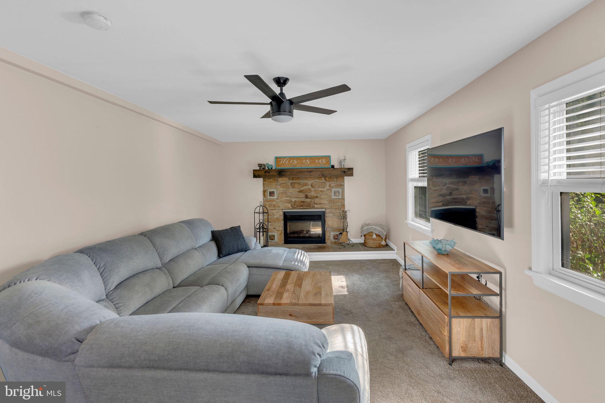 218 Keeley Avenue Doylestown, PA 18901 - Photo 14 of 42 a living room with furniture a flat screen tv and a fireplace