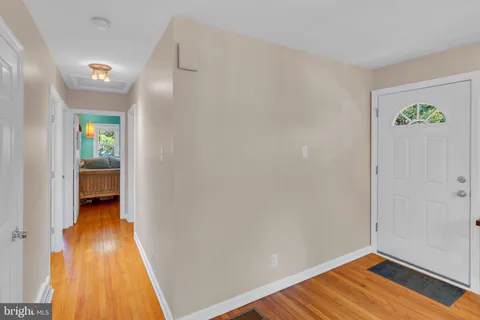 a view of a room with wooden floor and a window
