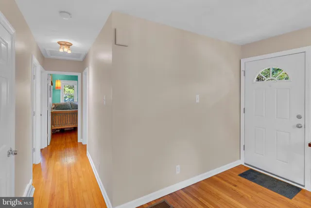 a view of a room with wooden floor and a window