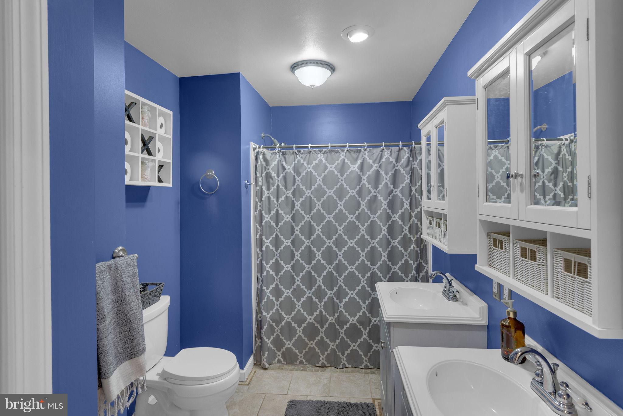 218 Keeley Avenue Doylestown, PA 18901 - Photo 21 of 42 a white toilet sitting next to a bathroom sink and a shower