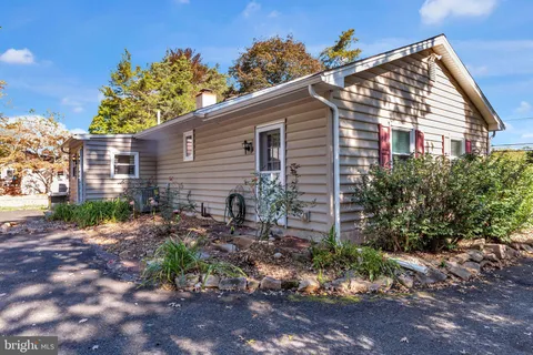a view of a house with a yard and a garden