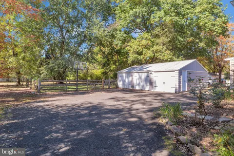 a view of a big yard with large trees