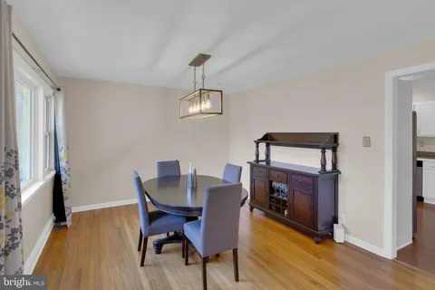 a view of a dining room with furniture wooden floor and a chandelier