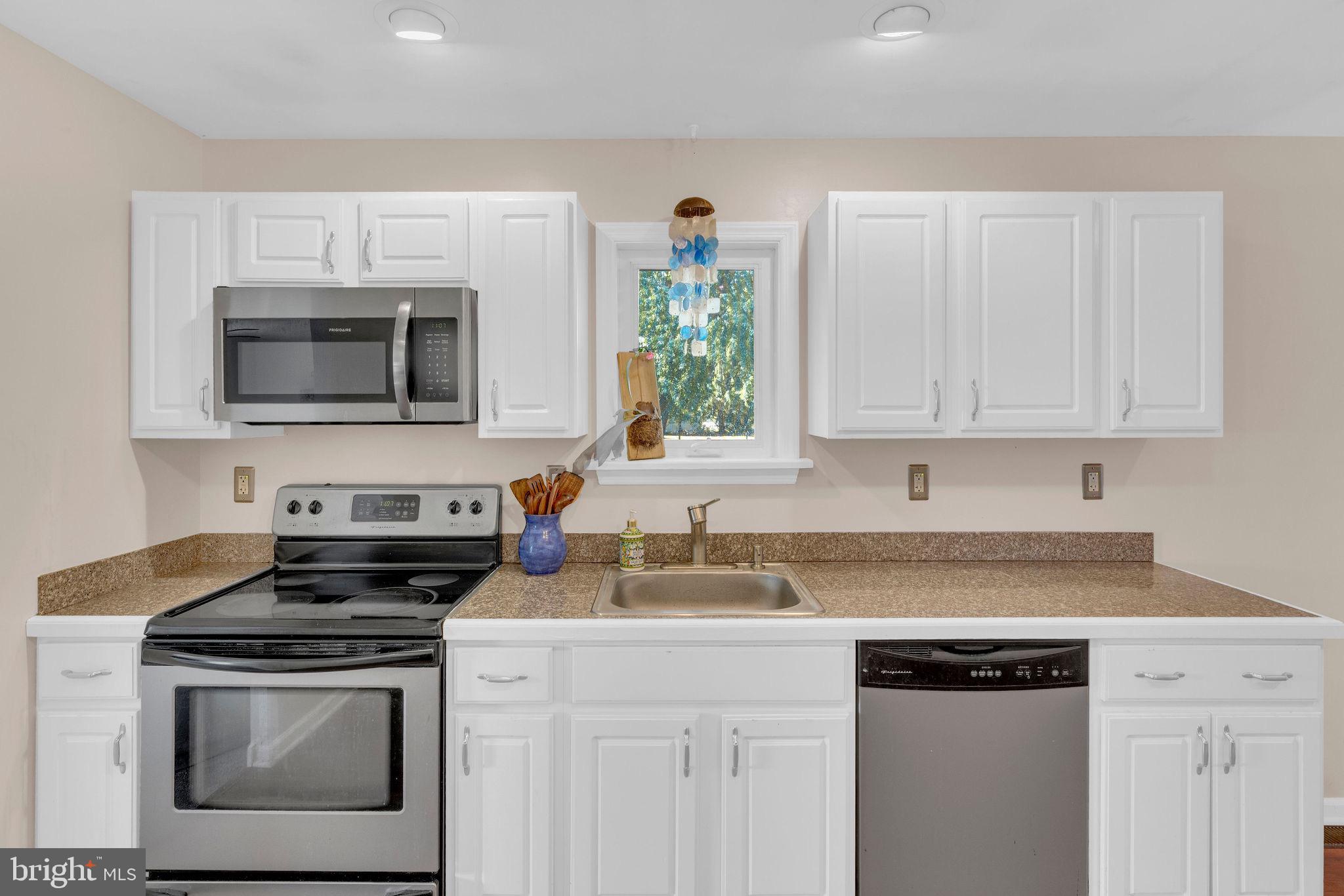 218 Keeley Avenue Doylestown, PA 18901 - Photo 10 of 42 a kitchen with granite countertop a stove a sink and a microwave